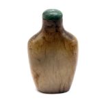 A carved jade snuff bottle with green jade stopper