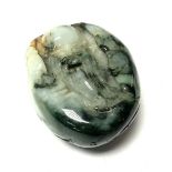 A carved jade pebble with a finely carved image of