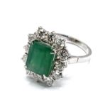 An 18ct white gold cushion cut emerald and diamond