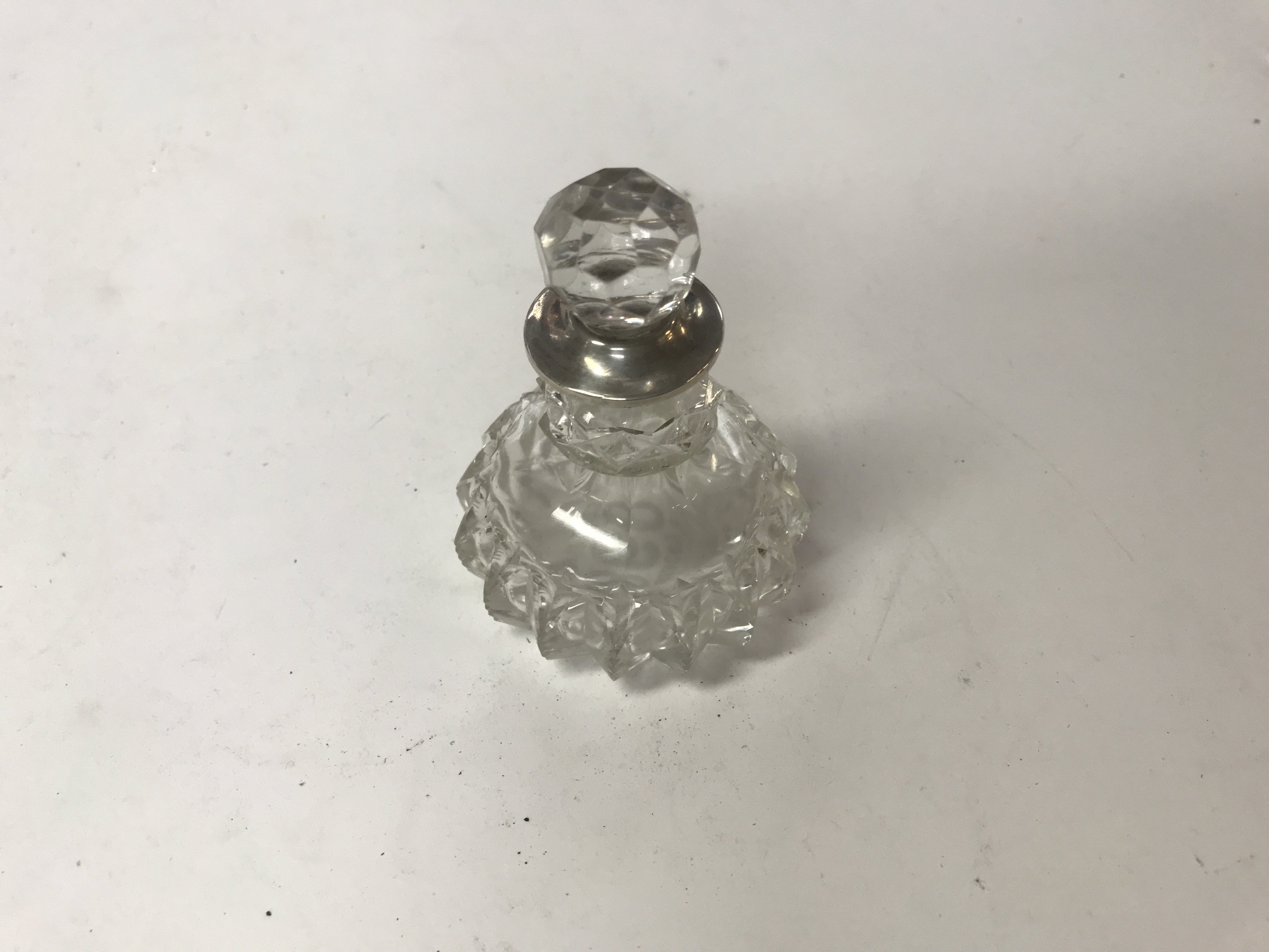 Glass perfume bottle with a silver collar, London