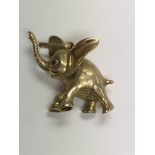 A 9 ct gold pendant in the form of a elephant tota