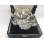 A cased silver bon bon dish with piercework decora