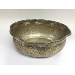 A Burmese silver bowl with repousse work decoratio