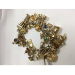 A 9 ct gold charm bracelet total weight 83 grams.