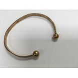 A 9ct gold bangle total weight 11.8 grams.