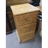 A pine three drawer chest, approx 47cm x 43cm x 80cm. Shipping category D.