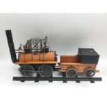 A cased model of a steam train and tender together
