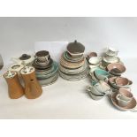 A collection of ceramic Poole cups, plates, jugs e