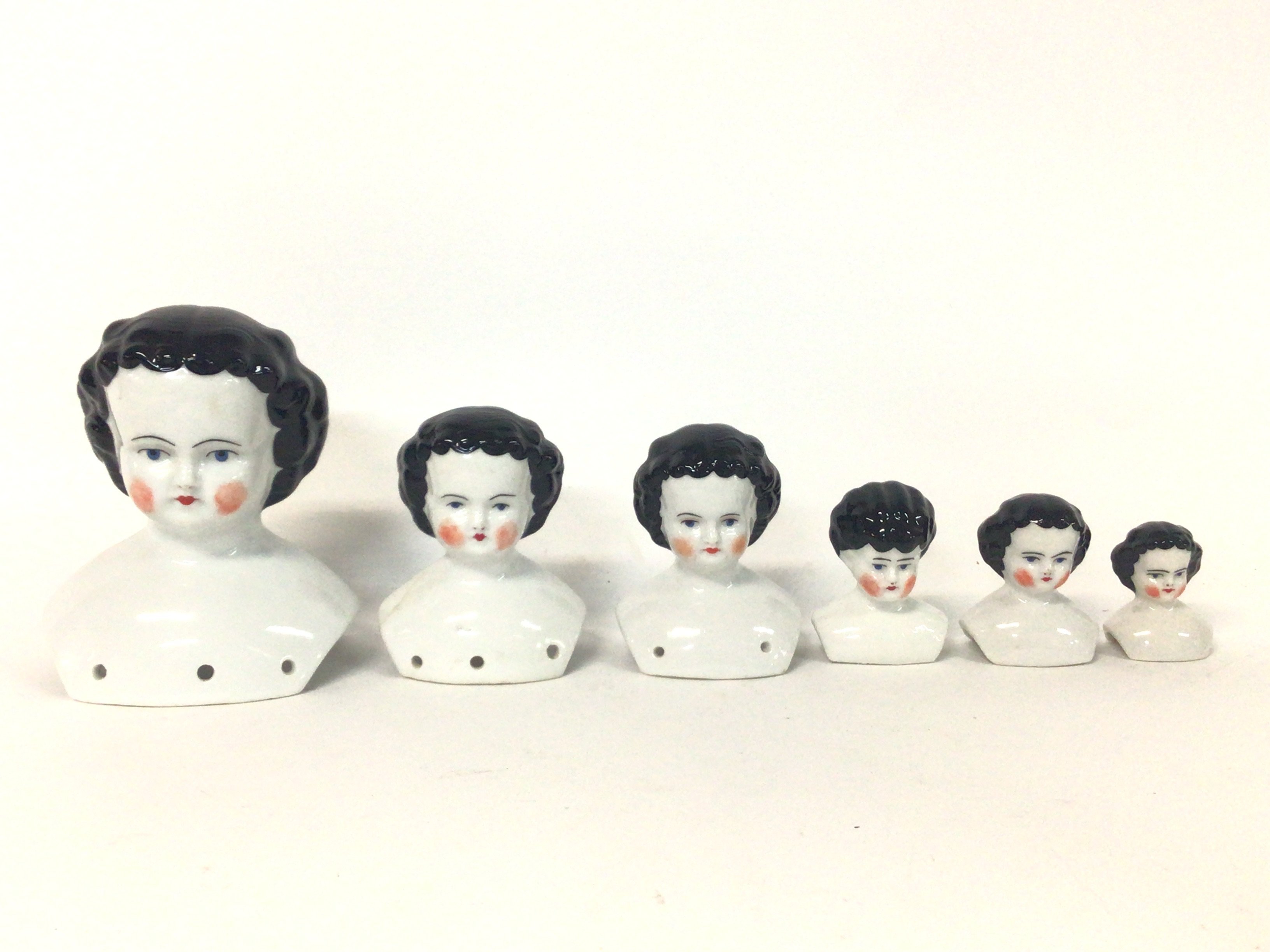 Ceramic doll heads, no obvious signs of restoratio