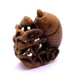 A Chinese carved fruit wood snuff bottle in the fo