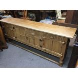 A light oak sideboard with panelled doors, approx 198cm x 40cm x 76cm. Shipping category D.