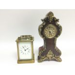 A brass cased carriage clock and a small mahogany