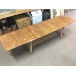 An Ercol drop leaf table, approx 160cm when extended. Shipping category D.