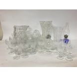 A large collection of cut glass including cups, va