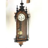 Wall Clock with key and pendulum ,in a oak case wi