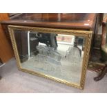 A gilt framed mirror etched with a traveller's wag