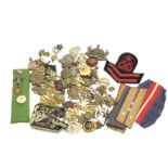 A collection of cap badges including Third Reich b