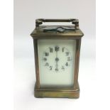 A brass cased carriage clock with key. Shipping ca