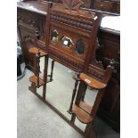 An Edwardian walnut overmantel mirror with bevelle