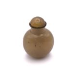 A polished agate snuff bottle of rounded form, 5cm