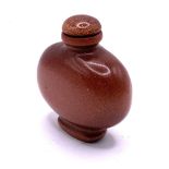 A modern polished goldstone snuff bottle. 6cm.