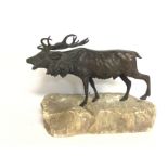 A bronze figure of a Stag on a rock base. Postage