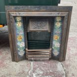 A Victorian cast iron and Ducal tile fire surround