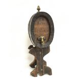 Small oval wooden barrel on stand with brass tap a