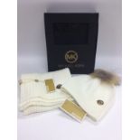 A boxed Michael Kors hat and scarf set. Shipping c