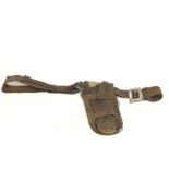 A vintage snake skin gun holster with silver buckl
