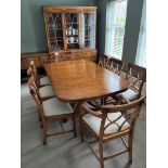 A Yew wood dining table and matching chairs,