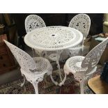 A white painted cast metal garden table and chairs