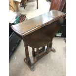 A small oak drop leaf table, approx height 60.5cm.