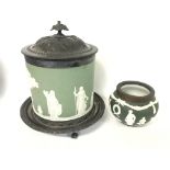 An early 20th century green wedgewood biscuit barr
