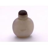 A polished agate bottle with a natural darkened ar