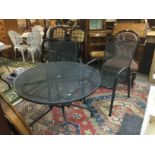 A modern garden table and two chairs plus some stone garden ornaments. Shipping category D.