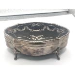 A silver trinket box the top with tortoiseshell in