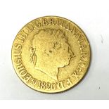 An 1820 sovereign, George III has a laureate head,