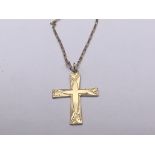 A 9carat gold cross pendent with attached gold cha