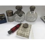 Three cut glass perfume bottles with silver mounts