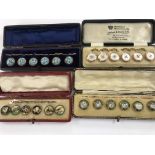 Four cased sets of press studs including enamel.