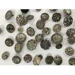 A collection of silver and white metal buttons inc
