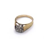 An 18carat gold ring set with a small solitaire di