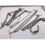 A collection of vintage silver watch chains and a