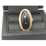 A 9carat gold ring set with a polished oval stone