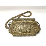 A heavy white metal filigree purse and attached me