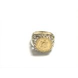 A 9ct gold ring inset with a pesos coin. Size N an