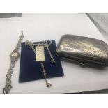 A silver cigarette case and a silver 1977 pendant