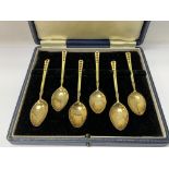 A cased set of 6 silver gilt and enamel coffee spo