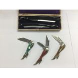 Three novelty pocket knives and a boxed pair of st